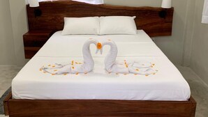 A neatly made bed with a wooden headboard, white bedding, and a decorative swan towel arrangement. - Arcadia
Lose the crowd and unplug to a 70 acre rainforest retreat. (Pont Cassé)