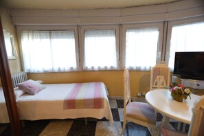 Quadruple Room, City View | Desk, laptop workspace, blackout drapes, soundproofing