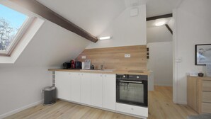 Een moderne keuken met een inbouwoven, een spoelbak en een raam.