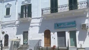 A white building with a storefront labeled "La Cantina."