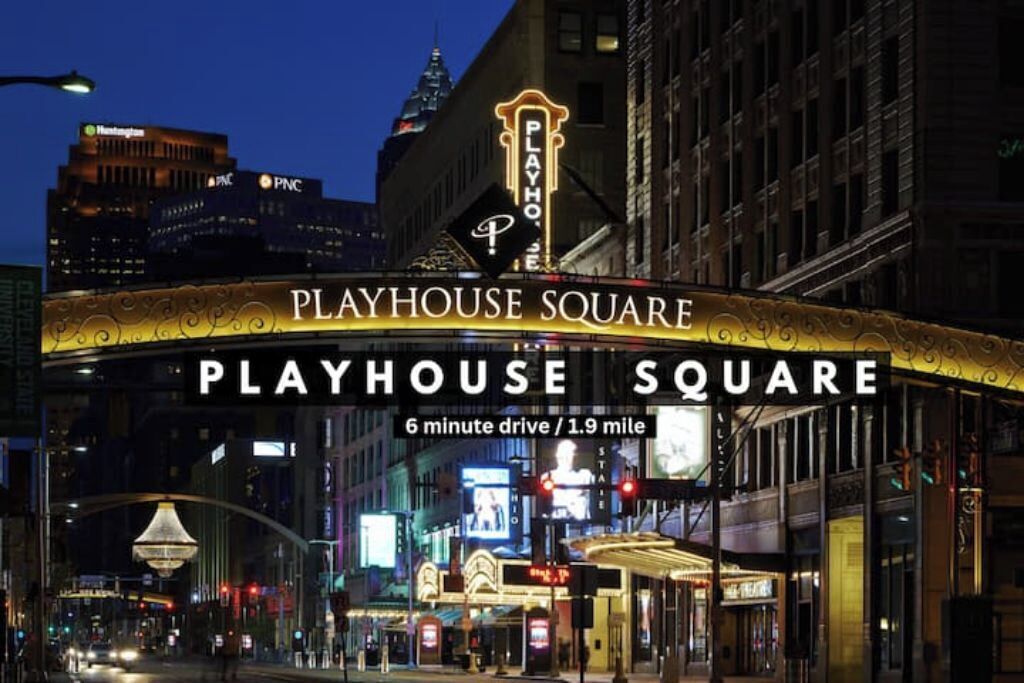 Playhouse Square with a prominent illuminated marquee and a sign indicating a 6-minute drive from the location.