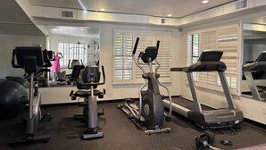A gym with exercise equipment, a mirrored wall, and large windows. - Be cool @ the pool! Quiet & private but near local attractions and conveniences! (Scottsdale)