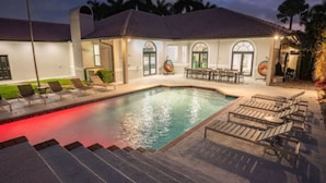 A swimming pool with steps leading up to it, surrounded by outdoor seating and a covered patio area. - 7000sf Mansion w/ Pool/Gameroom/Theater - N (Davie)