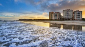A beachfront hotel with multiple high-rise buildings, a sandy beach, and ocean waves. - Spacious 2BR Villa at Marriott OceanWatch  Balcony  Resort Pools  Great Location (Myrtle Beach)