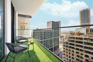 Deluxe Apartment, Balcony, City View | Living room | 40-inch LED TV with satellite channels, toys - Binghatti Suites by Hostiva - City View (Dubai)