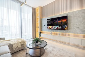 Deluxe Apartment, Balcony, City View | Living room | 40-inch LED TV with satellite channels, toys - Binghatti Suites by Hostiva - City View (Dubai)