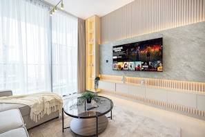 Deluxe Apartment, Balcony, City View | Living area | 40-inch LED TV with satellite channels