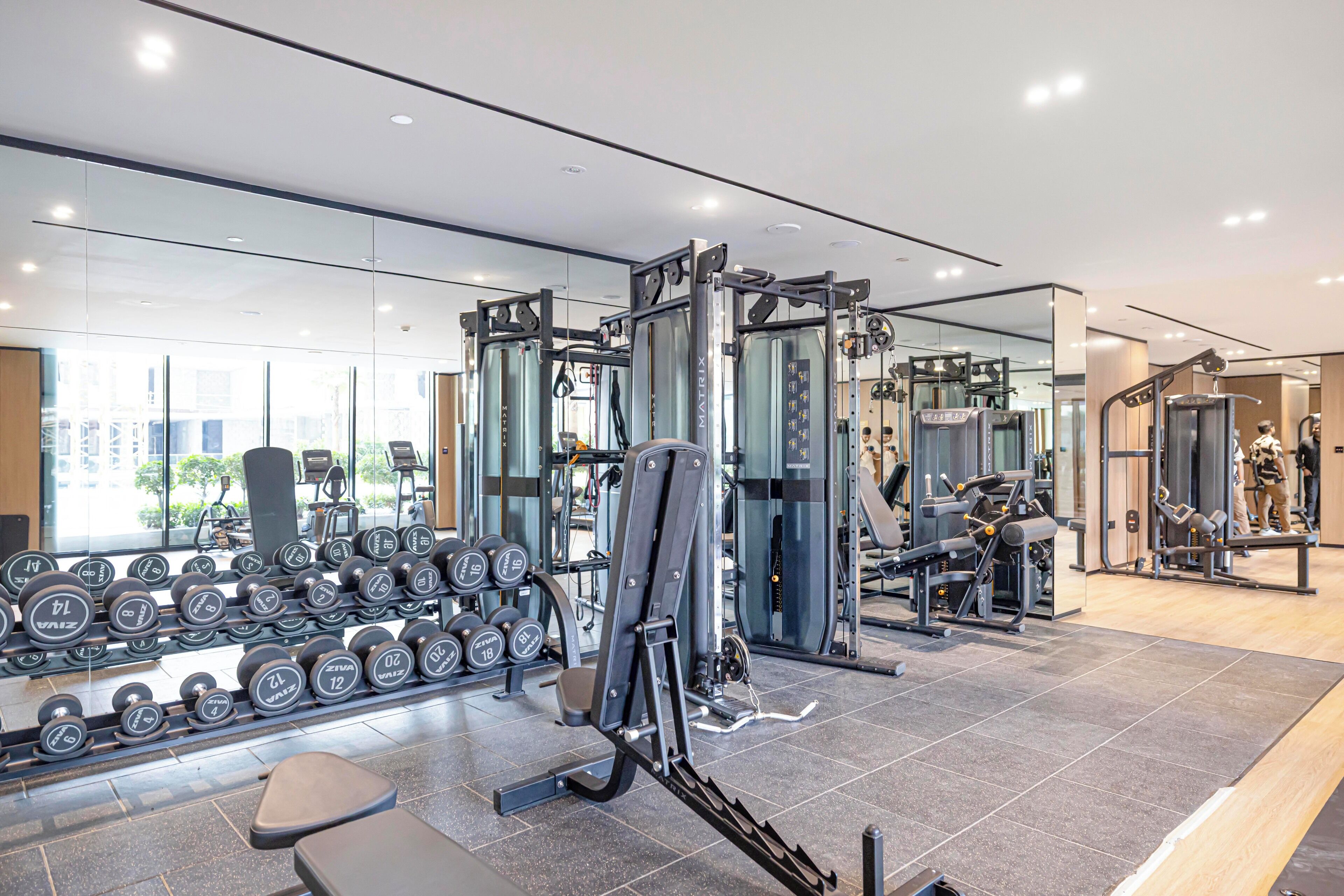 Een moderne sportschool met diverse fitnessapparaten, waaronder gewichten en krachtapparaten.