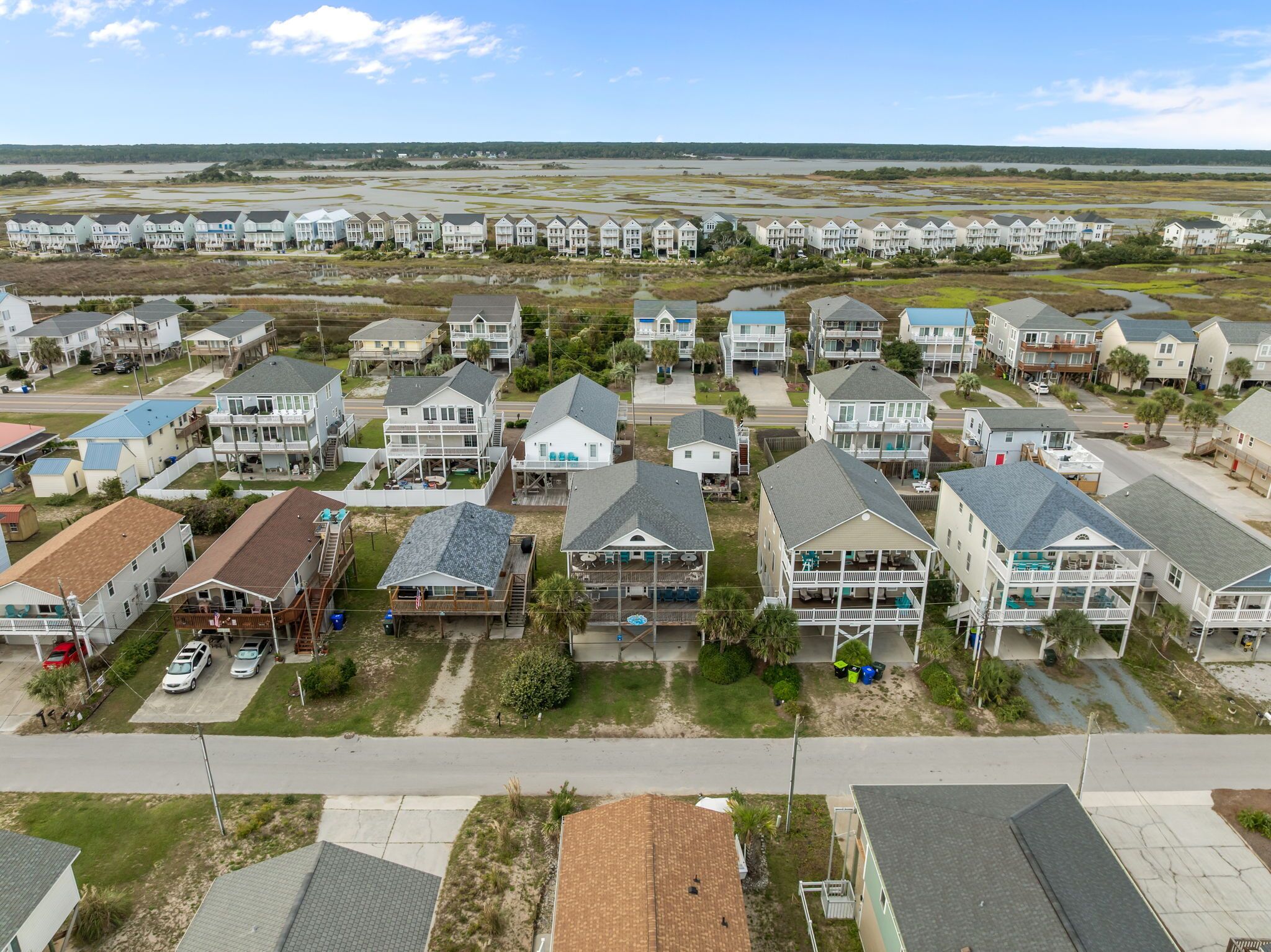 A coastal residential area with houses featuring balconies and waterfront views.
