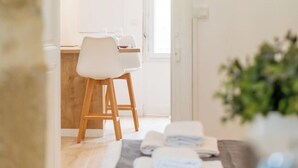 Ein Zimmer mit einem Bett, einem Sessel und einem Tisch mit Handtüchern.