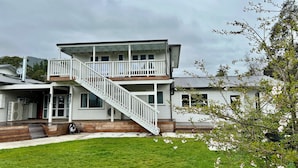 A two-story house with a balcony and a staircase leading to the upper floor. - Maymorn Valley Stay (Upper Hutt)