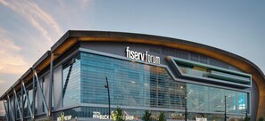 A modern building with a curved facade and the text 'fiserv forum' on the front.