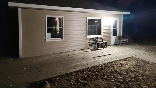 A single-story house with a covered porch, two windows, and a door. - Charming updated 1-bedroom apartment in brilliant Midland with AC (Midland)