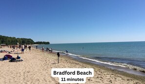 A beach scene with people and beach equipment.