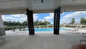 An outdoor pool area with lounge chairs and a clear view of the pool. - Welcoming Spacious Crestview Home w/ Pool Access & Fire Pit (Crestview)