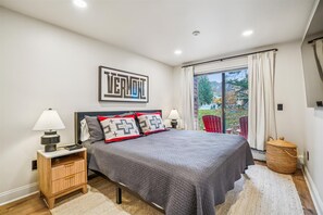 Second Bedroom with Outdoor Access - This welcoming bedroom offers comfortable accommodations and easy access to the balcony and surrounding views. - Ski In/Ski Out Pico Resort Unit E106: 3 bedroom newly renovated condo (Killington)