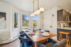 Scenic Dining Area - Enjoy morning coffee or evening dinners beside expansive windows that showcase the surrounding landscape. - Ski In/Ski Out Pico Resort Unit E106: 3 bedroom newly renovated condo (Killington)