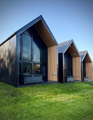 A modern building with large windows and wooden accents. - The Lofts @ Frost Fire- Cabin C (Walhalla)