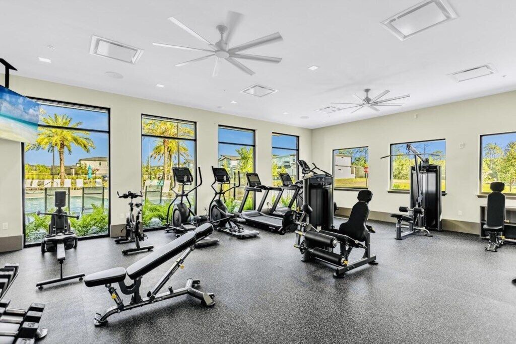 A gym with treadmills, weight machines, and benches.