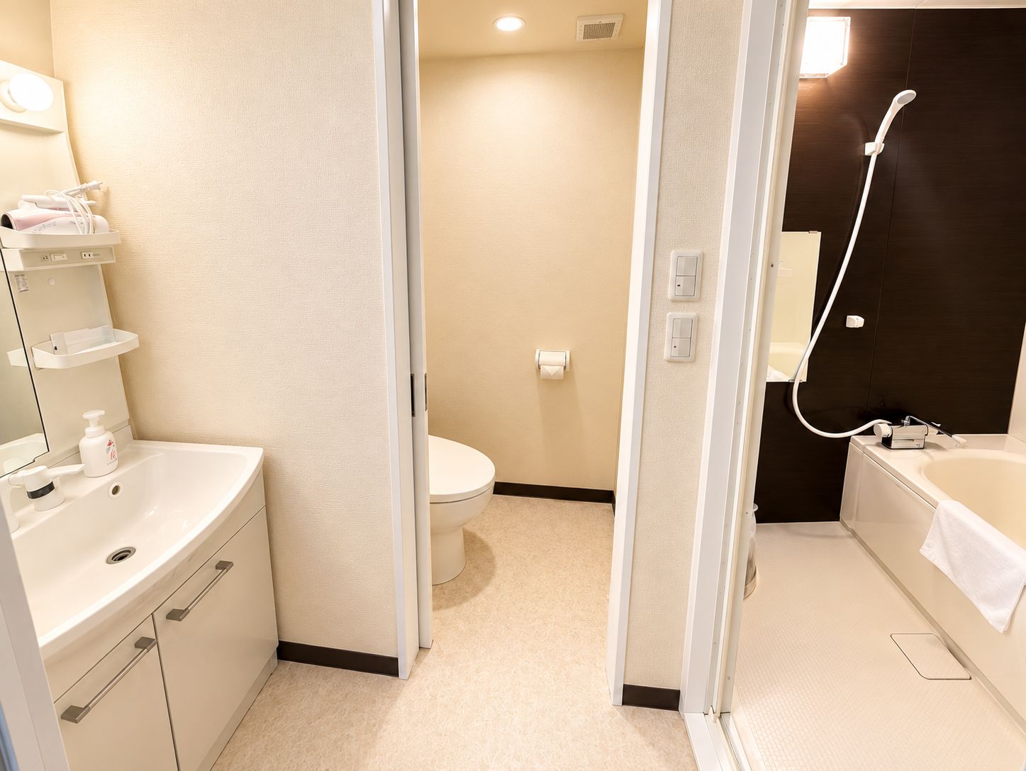 A modern bathroom with a sink, toilet, and shower area.