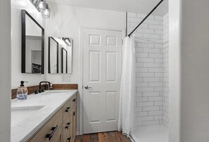 Shower, hair dryer, towels, toilet paper