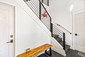 A staircase with black railings and a red decorative element. - Moonlight Basin Retreat | Ski-In/Out + Patio (Big Sky)