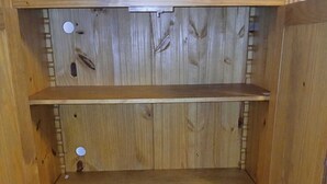 A wooden cabinet with three shelves.