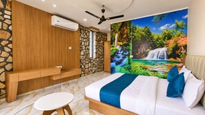 A bedroom with a bed, a desk, and a wall-mounted air conditioner. - Divydrashti Resorts (Waghoriya)