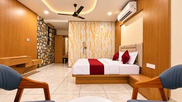 A modern bedroom with a bed, bedside tables, a ceiling fan, and an air conditioning unit.
