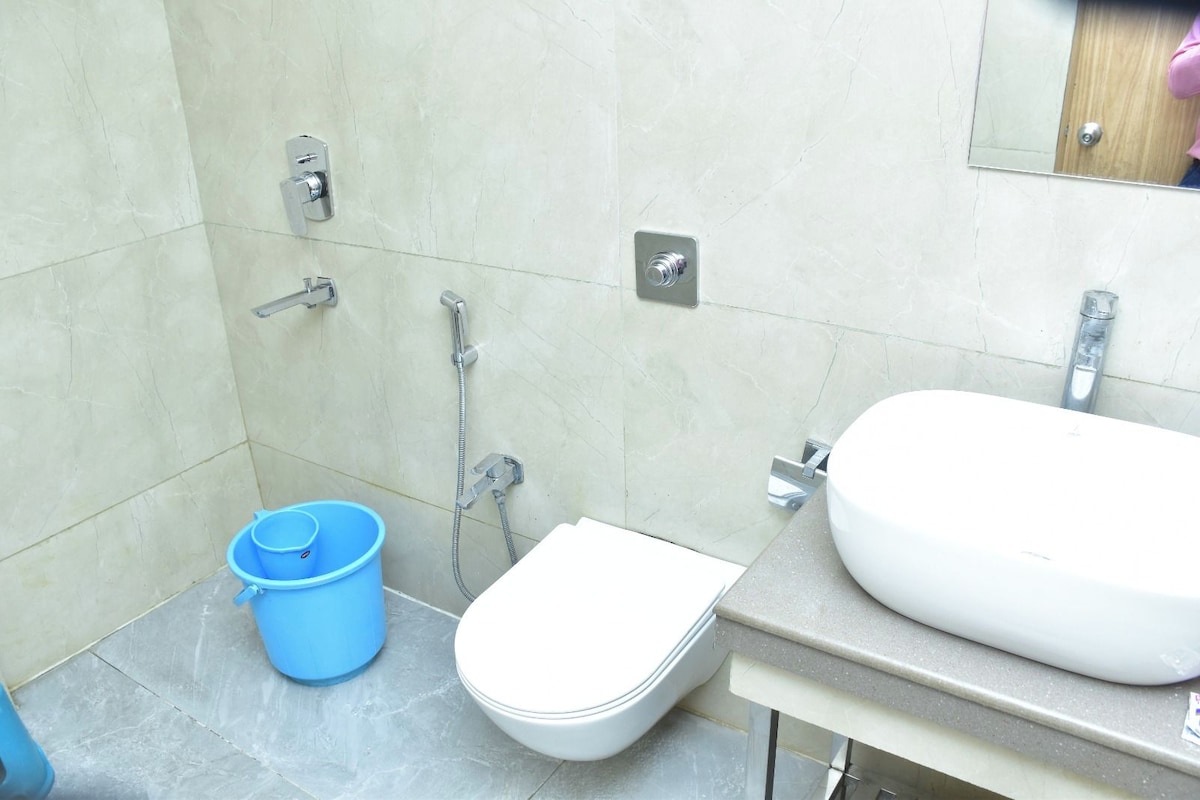 A bathroom with a toilet, a sink, and a shower.