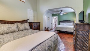 A bedroom with two beds, a wooden dresser, and a ceiling fan. - Route 66 Retreat: Dog-Friendly Home in Williams (Williams)