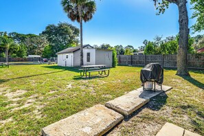 A backyard with a small white shed, a covered grill, and a concrete stepping stone path. - See the Manatees! Homosassa Studio 2 Mi to River (Homosassa)
