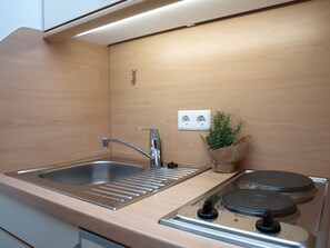 Fridge, microwave, stovetop, coffee/tea maker