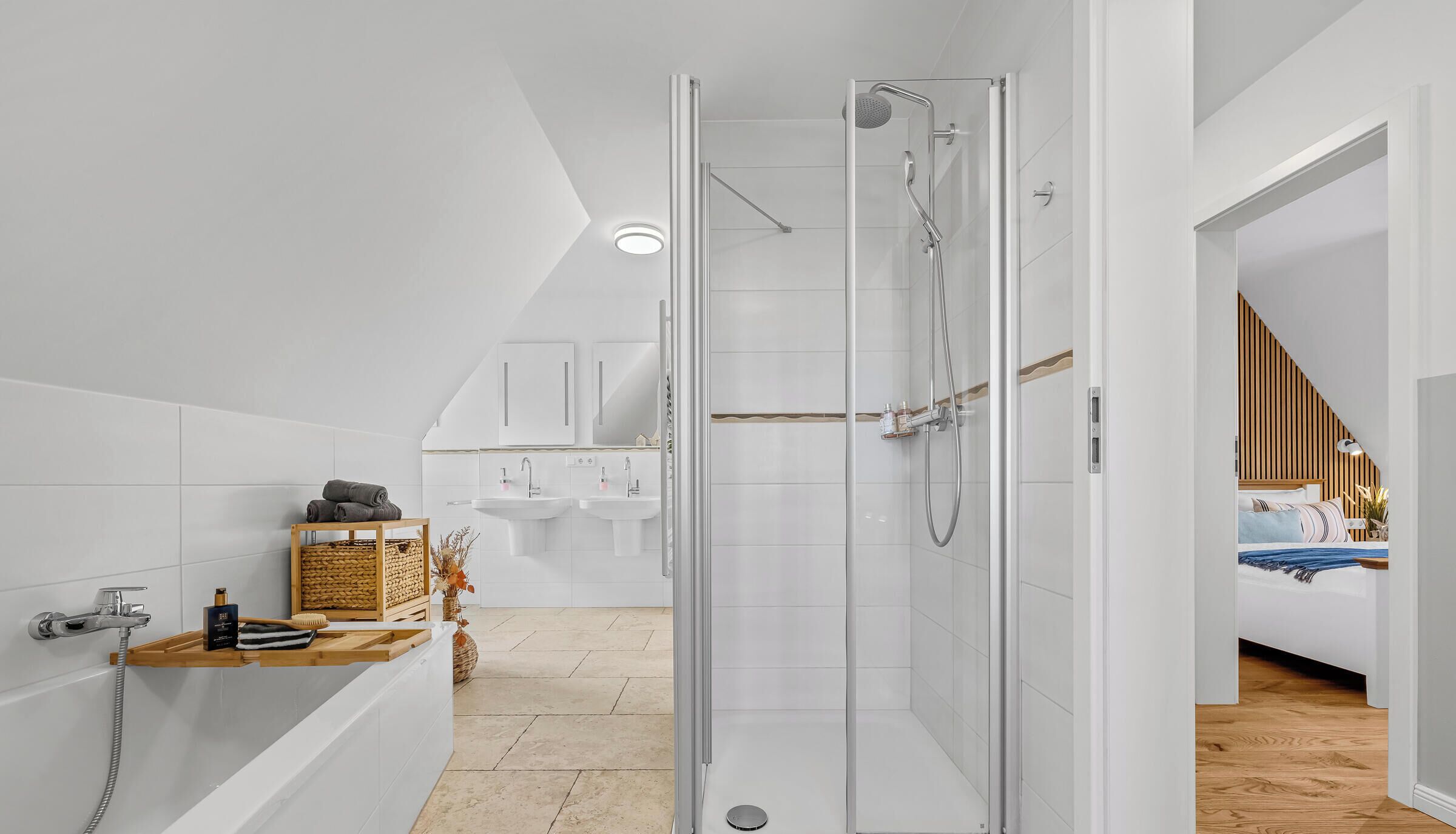 A modern bathroom with a glass shower enclosure, a bathtub, and a vanity with a sink.