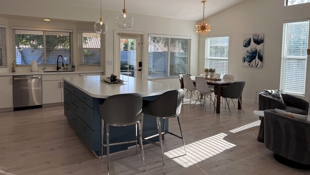 A modern kitchen with a central island, bar stools, and pendant lighting. - Prime North Scottsdale location with private pool and hot tub (Scottsdale)