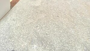 Corredor amplo e bem iluminado, com um carro estacionado no final.