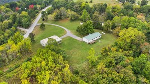 An aerial view of a rural property with a large house, a barn, and surrounding wooded areas. - Nature's Sanctuary-3 Mi to Downtown Eureka Springs (Eureka Springs)