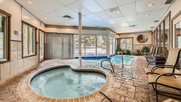 A spa area with a hot tub, seating, and a view of the outside. - Pet Friendly Studio Cross Creek Condo - CC102A (Frisco)