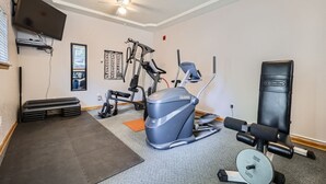 A home gym with a treadmill, weight bench, and various exercise equipment. - Pet Friendly Studio Cross Creek Condo - CC102A (Frisco)