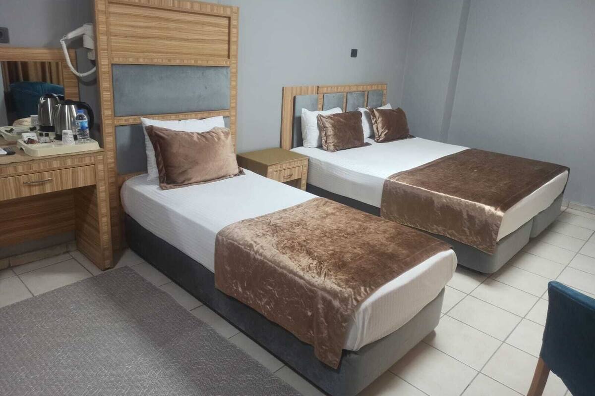 Habitación triple familiar, vista a la ciudad | Caja de seguridad en la habitación, cortinas blackout y insonorización