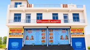 A hotel with a signboard for Hotel Khatishyam Residency, featuring amenities like A.C/non A.C rooms, a restaurant, and a conference hall. - Hotel Khatushyam Residency (Shri Madhopur)