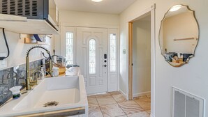 A modern bathroom with a white sink, stainless steel faucet, and a large mirror. - Shop & Explore: Duplex Unit 8 Mi to NRG Stadium! (Houston)