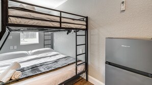 A bunk bed with a mattress and pillows, a wooden ladder, and a built-in shelf. A modern refrigerator is to the right. - Anglers Dream: Studio 2 Mi to 7 Sisters Springs! (Homosassa)