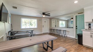 A spacious kitchen with wooden countertops, a dining area with a large table and benches, and a ceiling fan. - 2 Mi to 7 Sisters Springs! Home w/ Resort Perks (Homosassa)