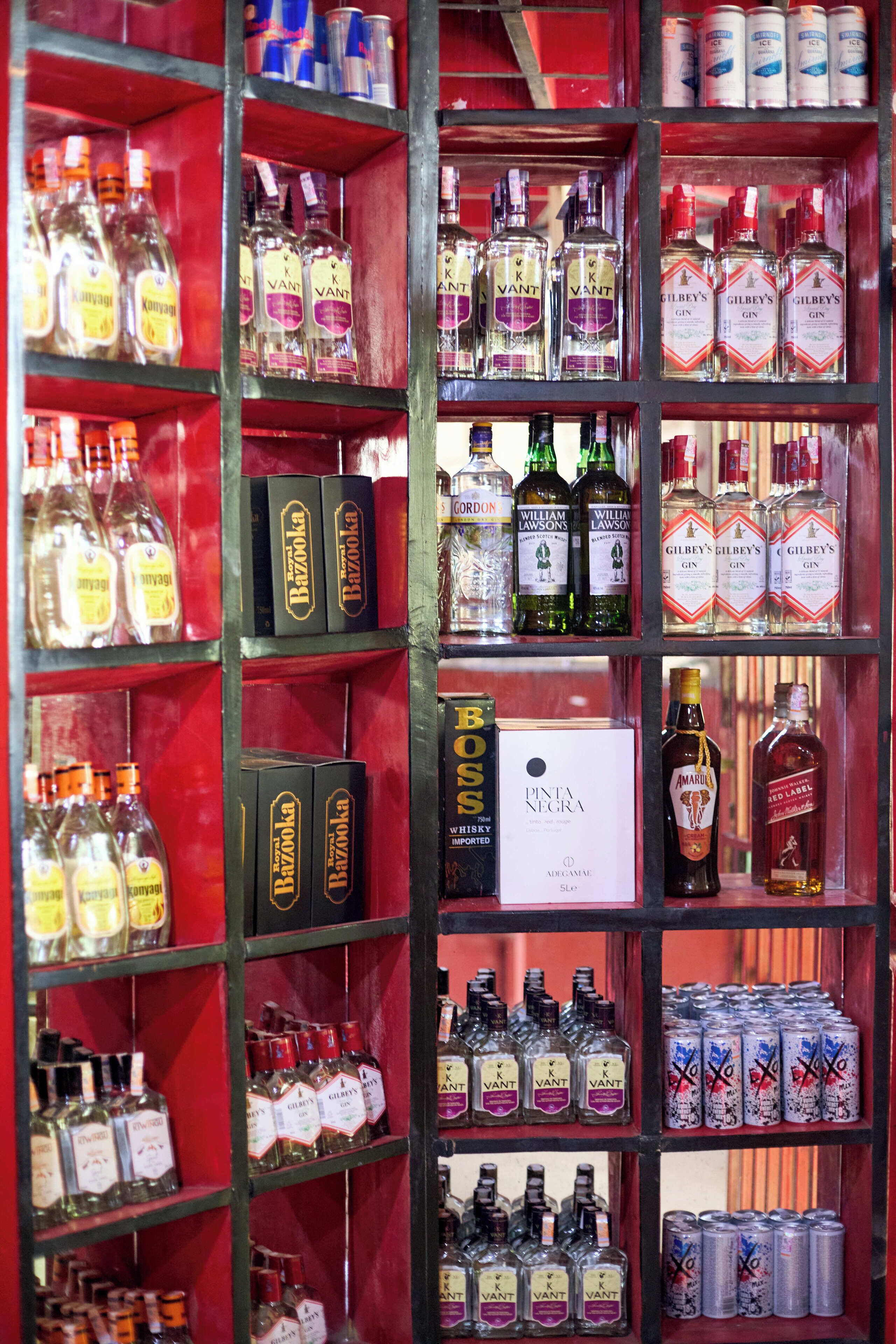 A liquor store with various bottles of gin, whiskey, and other spirits.