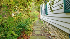 A narrow stone pathway leading to a white house with green shutters. - 1 Mi to Dtwn Binghamton: Pet-friendly Home w/ Deck (Binghamton)
