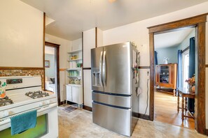 A kitchen with a stainless steel refrigerator, a white stove, and a wooden cabinet. - 1 Mi to Dtwn Binghamton: Pet-friendly Home w/ Deck (Binghamton)