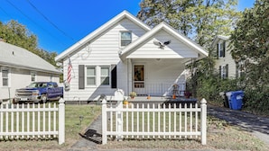 A white house with a porch, a blue truck parked in front, and a white picket fence. - 2 Mi to Mohegan Sun & Dtwn: Home in Norwich (Norwich)