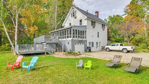 A two-story house with a porch, a garage, and a driveway.