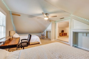 A bedroom with a bed, desk, chair, ceiling fan, and string lights. - Walk to Dtwn Hahira: Inviting Home w/ Pool & Yard! (Hahira)